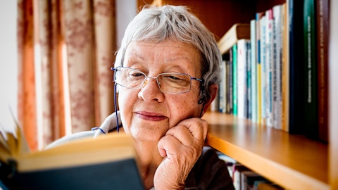 Eldre kvinne som leser en bok.